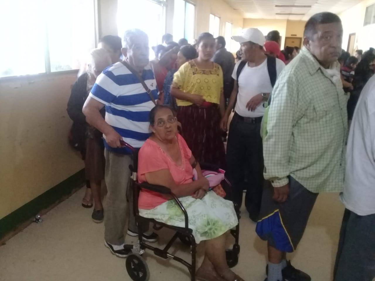 A donated wheelchair helps an elderly woman into Fray Hospital