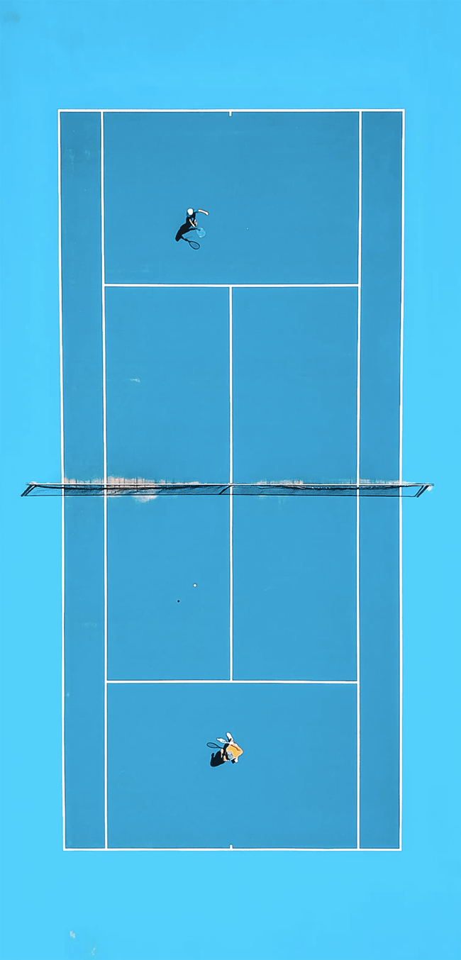 Bird's-eye view of tennis game on blue clay
