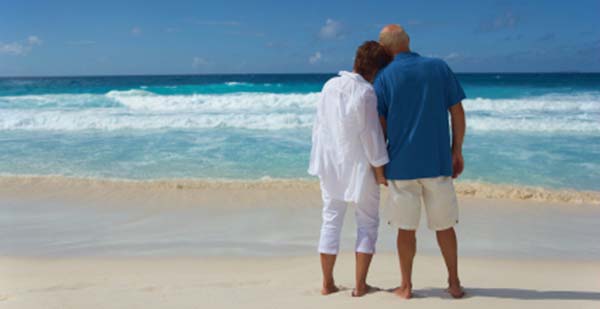 photo of a couple on the beach, representing peace of mind while on vacation