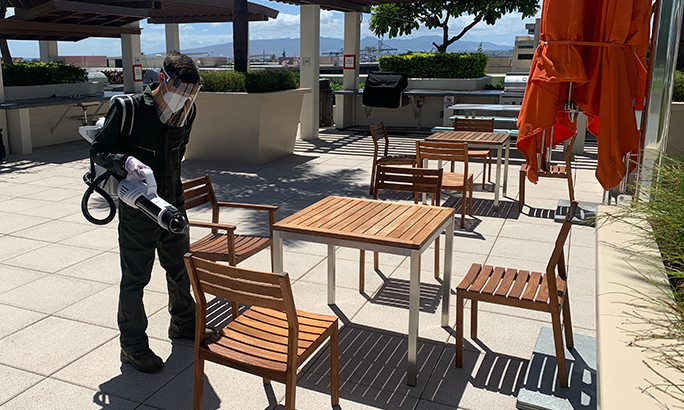 Man disinfecting a hotel