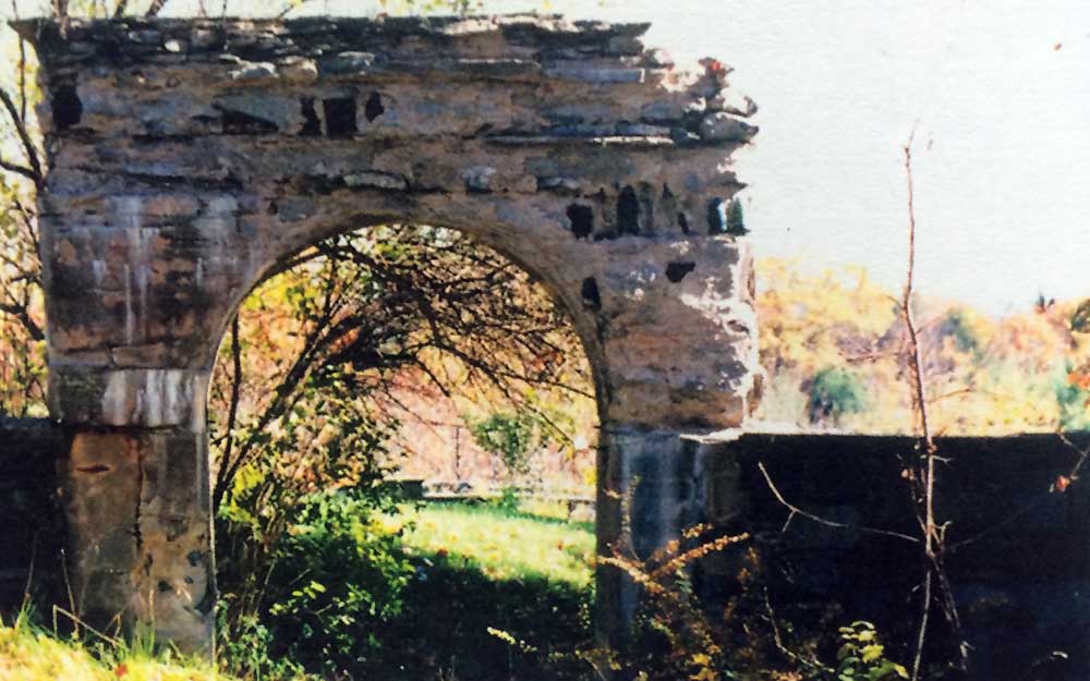 archway embedded with wine bottles