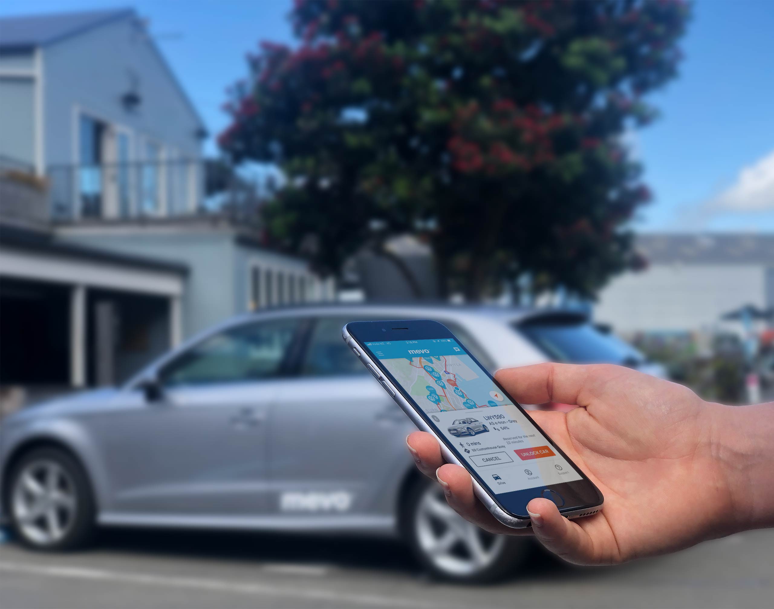 Mevo app on an iPhone being held in front of a Mevo car
